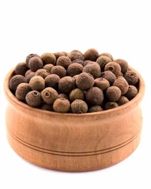 A wooden bowl filled with Allspice, displayed against a white background. The whole organic allspice berries are small, round, and have a brown color with a slightly coarse texture.