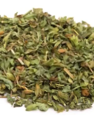 A small pile of dried lemon balm leaves is scattered on a white surface. The leaves are green and finely chopped, commonly used as a culinary herb for seasoning and garnishing various dishes. Nearby, an Egyptian Lemon Balm B2B supplier showcases the versatility of Melissa officinalis in culinary applications.