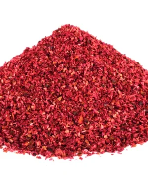 A mound of vibrant, natural Sumac is presented against a white background, its finely ground texture and bright color hinting at a rich, potentially spicy seasoning. This culinary staple is commonly used to enhance flavor and add heat to various dishes. Ideal for those seeking authentic, bold taste in their Sumac purchases.
