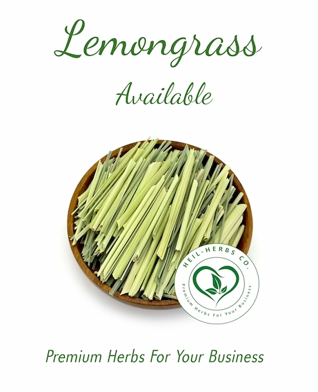 A wooden bowl filled with cut lemongrass pieces is centered on a white background. Above the bowl, the text "Lemongrass Available" is displayed in green. Below the bowl, the phrase "Premium Herbs For Your Business" along with the HEIL-HERBS CO. logo is shown.