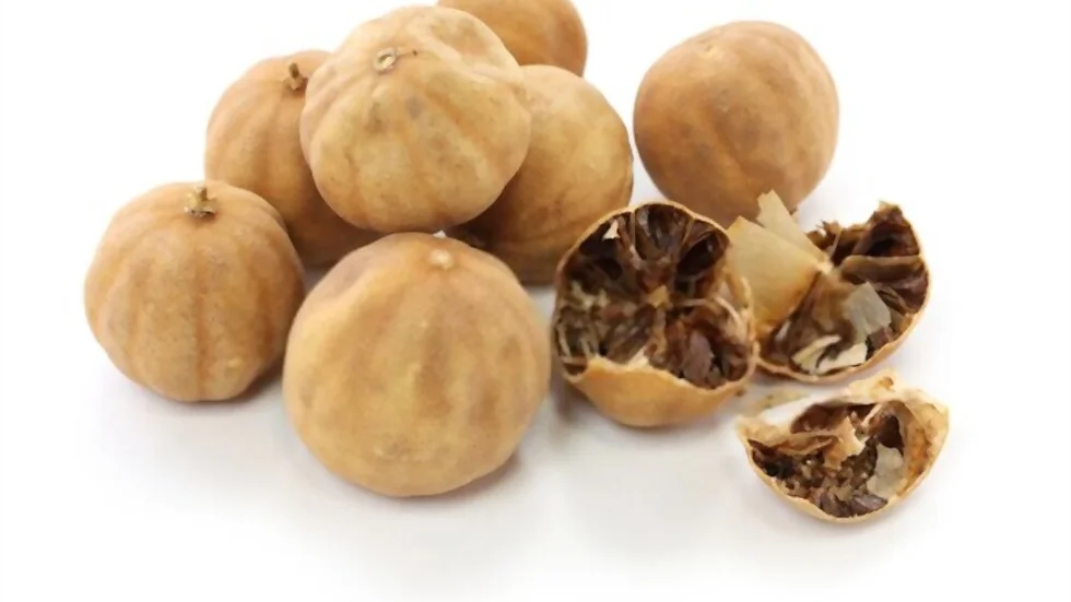 A cluster of Lemon dried, with a few split open to reveal their desiccated interiors. The lemons, featuring a beige and wrinkled outer skin, are arranged on a white background.